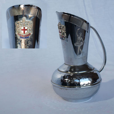 CHROME EWER BEARING THE CITY OF LONDON COAT OF ARMS BADGE.